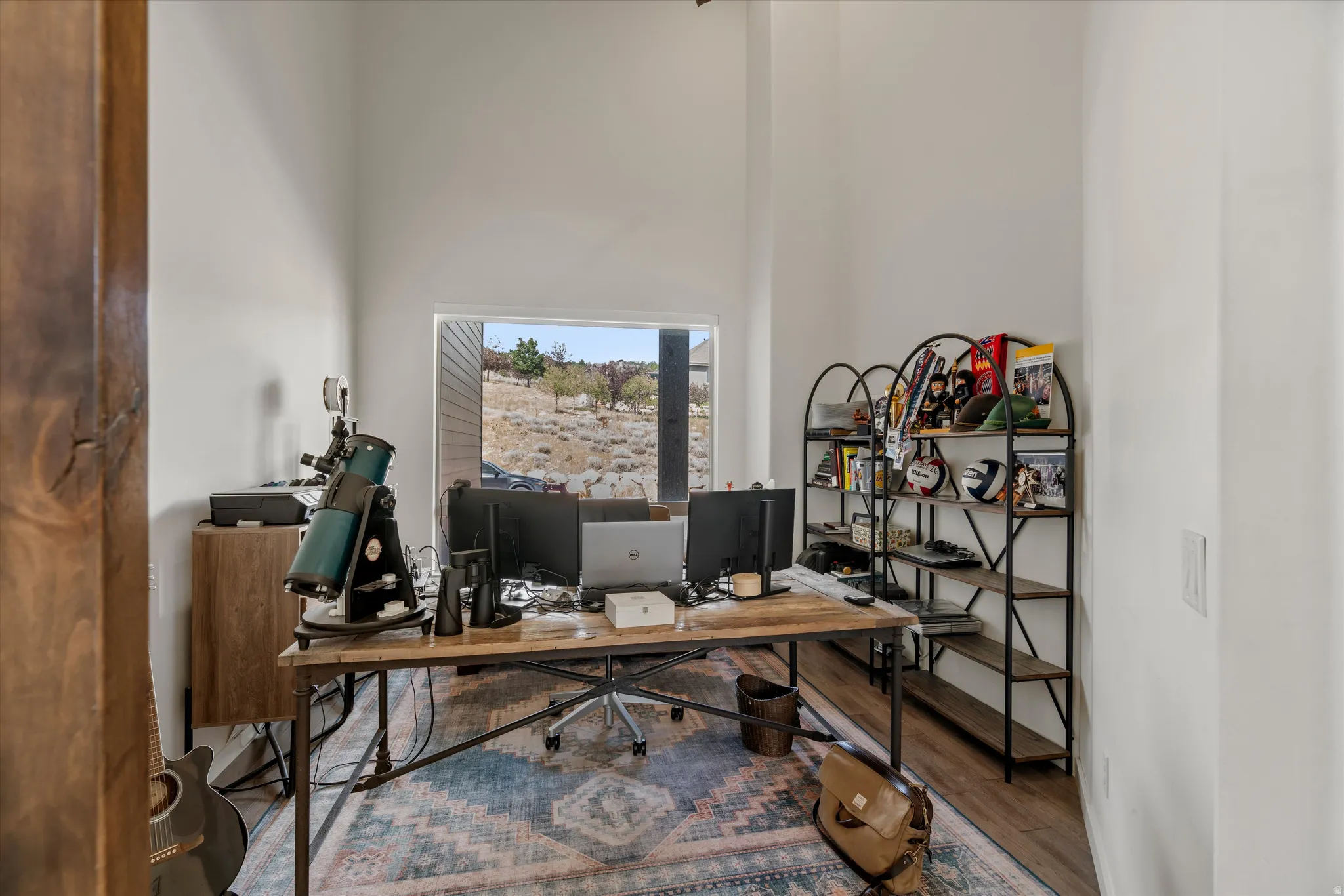 Dedicated room with a large window offering natural light and views of the arid landscape