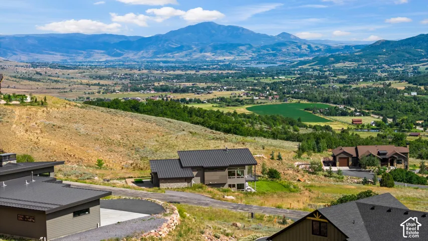 Expansive mountain landscape with distant valley and cultivated fields