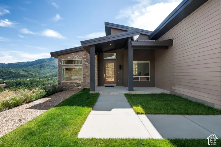 Contemporary architectural design featuring a prominent stone facade and horizontal siding