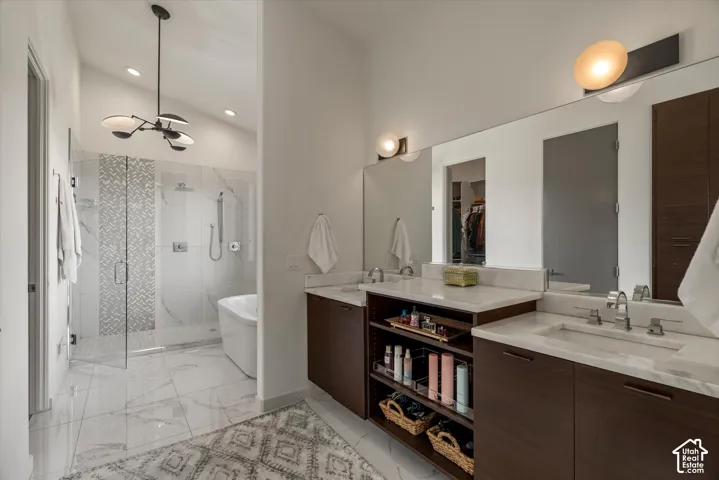 Dual vanity featuring wood-finish cabinetry, white countertops, and undermount sinks