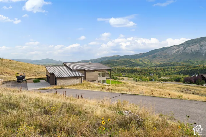 Contemporary exterior with a metal roof, stone accents, and expansive windows