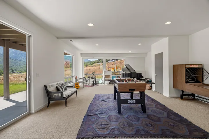 Spacious lower level featuring broad windows and a sliding glass door, providing abundant natural light