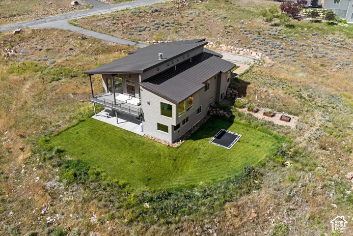 Modern architectural design featuring a multi-level structure with a dark metal roof