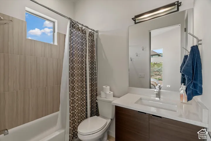 Bathroom vanity featuring a light-toned countertop with an integrated rectangular sink