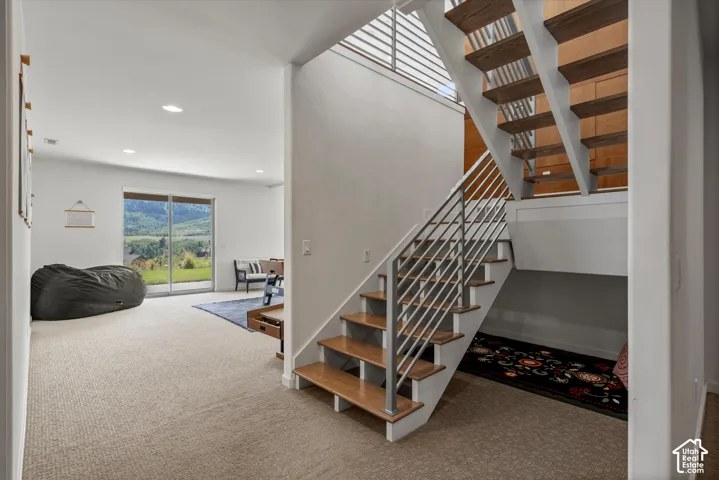 Open-riser staircase with wood-finish treads and metal railing