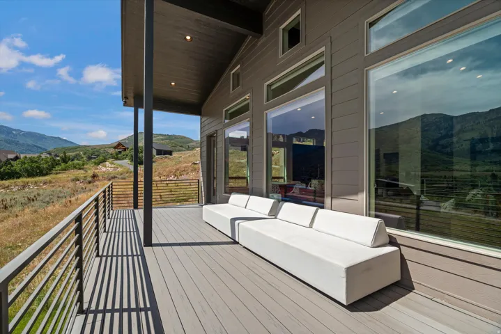 Expansive outdoor deck featuring composite decking and modern metal railings