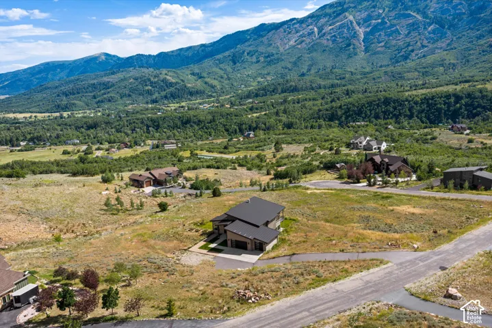 Contemporary mountain residence featuring a multi-level design and an attached three-car garage