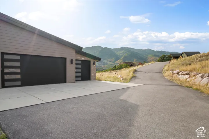 Attached two-car garage with modern black doors featuring frosted glass panels