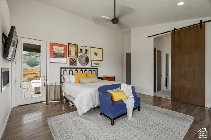 Spacious room featuring wood-finish flooring, a contemporary ceiling fan, and recessed lighting