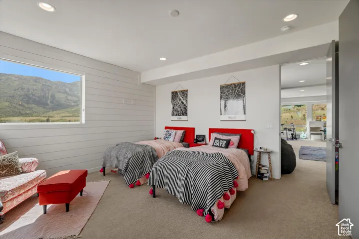 Carpeted room featuring a large horizontal window and shiplap wall paneling