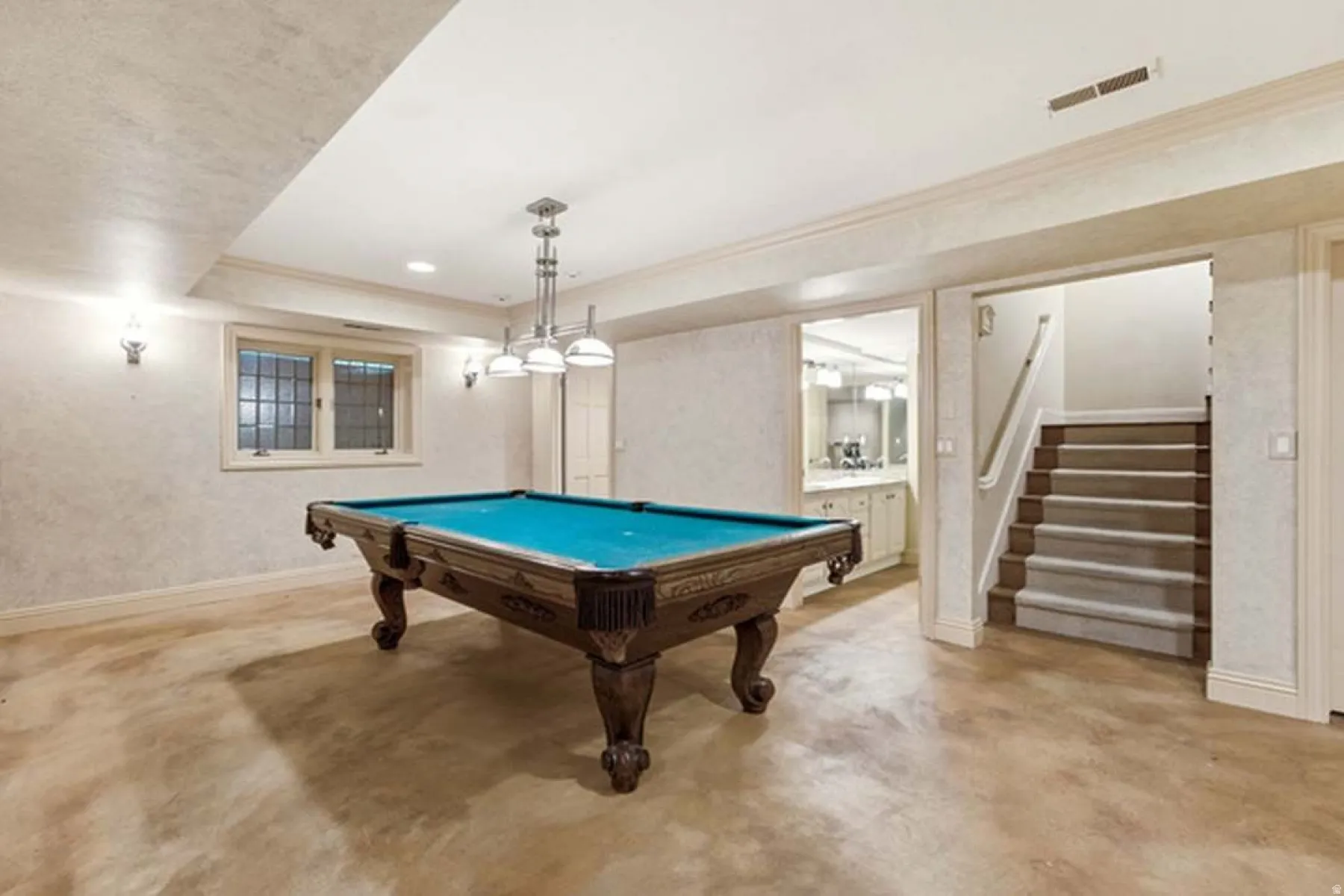 Open recreational space with recessed lighting, crown molding, and sconce fixtures