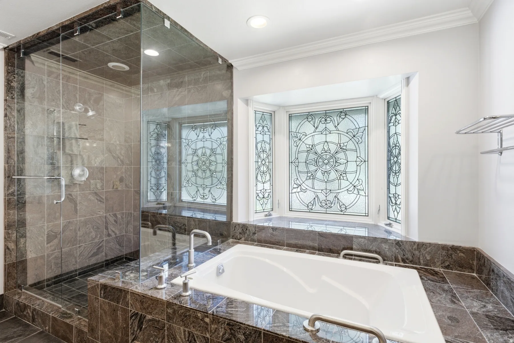 Glass-enclosed shower with stone tile, a built-in soaking tub, stone tile surround, and decorative bay window