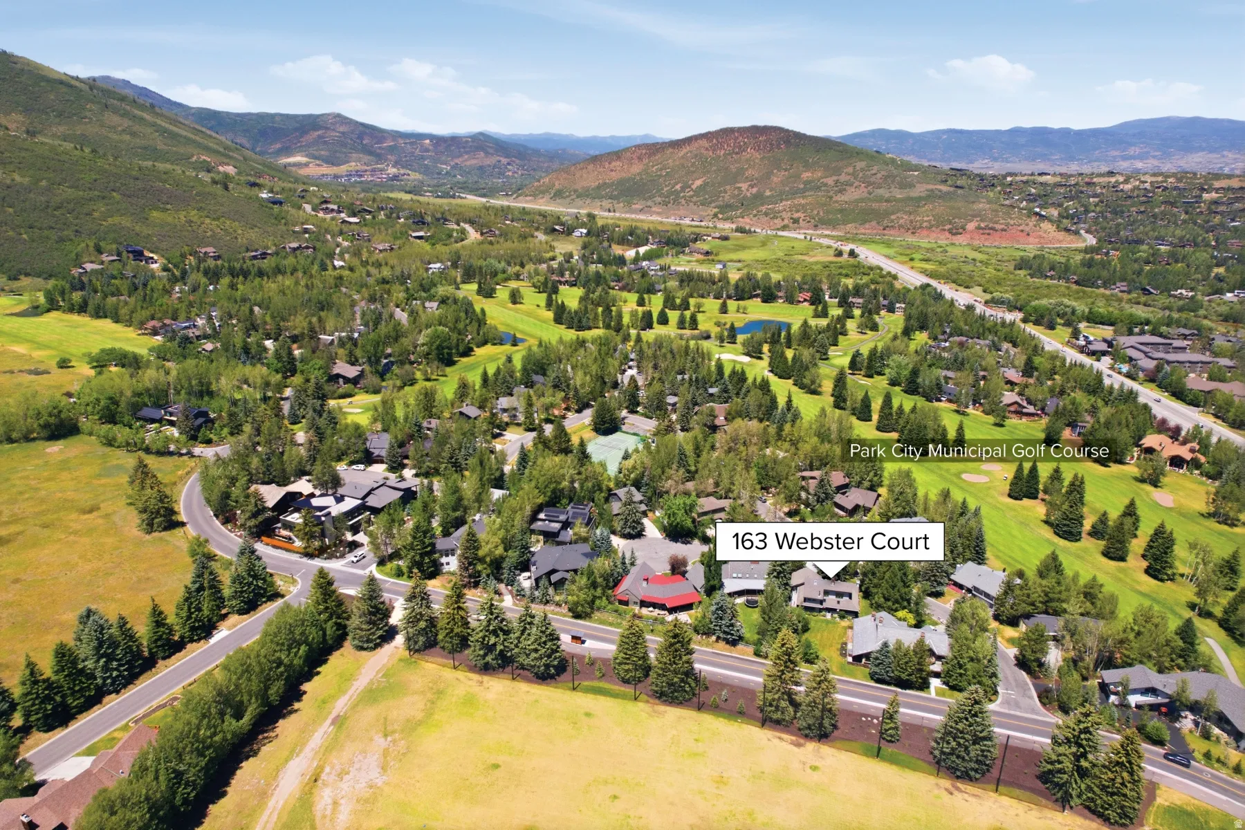 Aerial perspective of the Park City Municipal Golf Course and surrounding residences, featuring mature trees and mountain terrain
