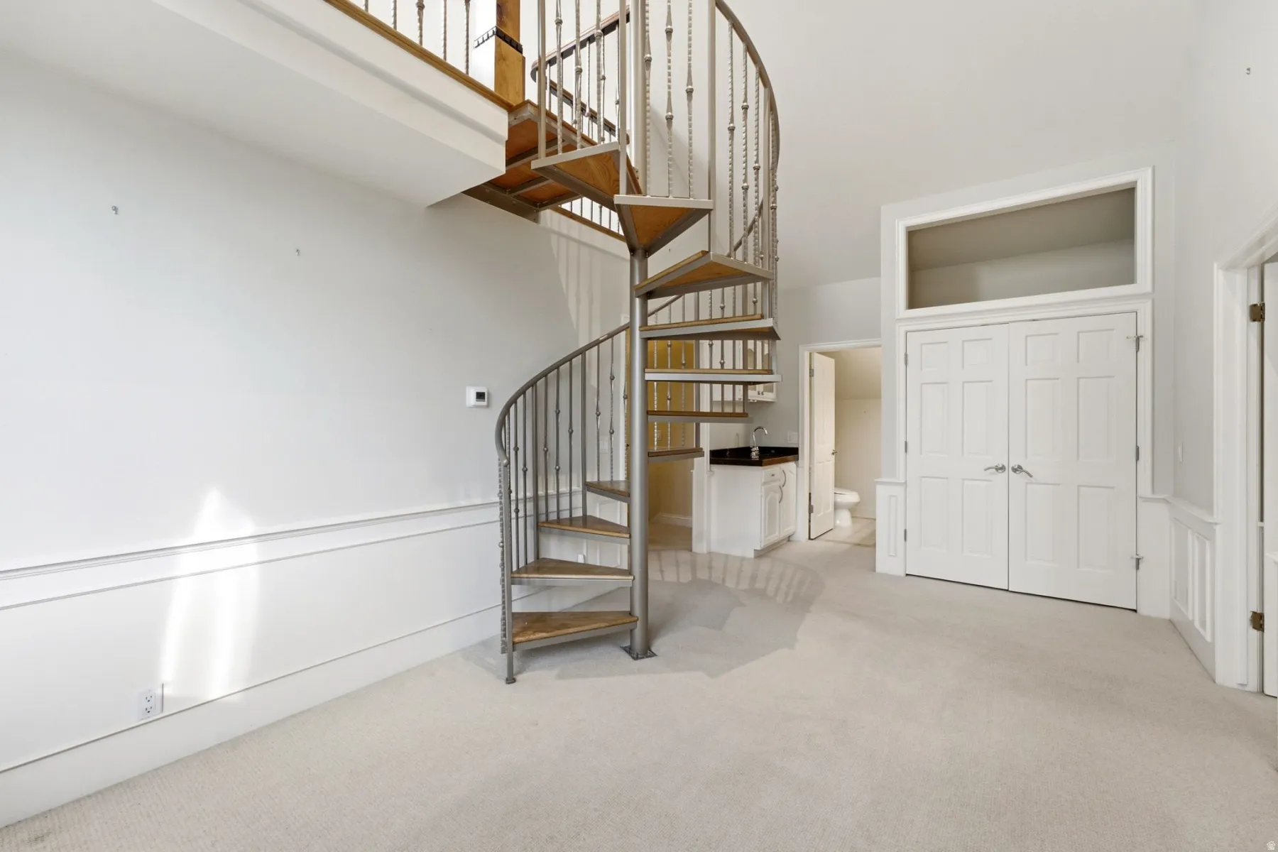 Spiral staircase with wood treads and metal balusters