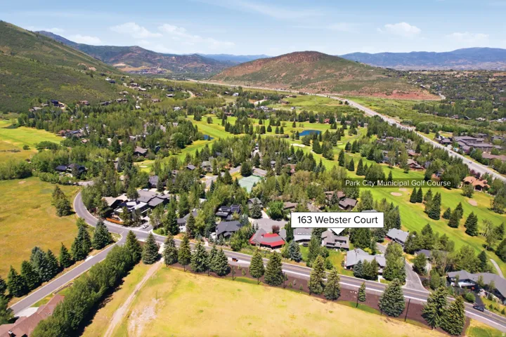 Aerial perspective of the Park City Municipal Golf Course and surrounding residences, featuring mature trees and mountain terrain