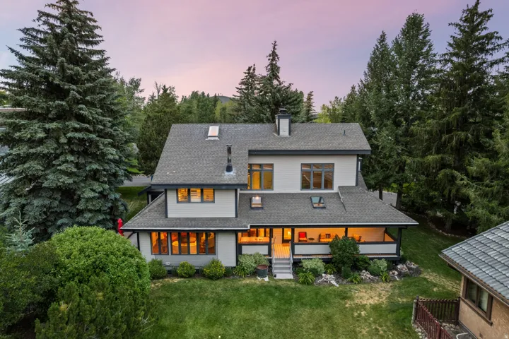 Multi-level residence featuring a covered patio, multiple skylights, and a detached structure