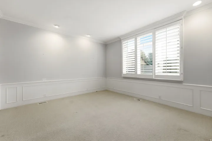 Recessed lighting, crown molding, wainscoting, and plantation shutters