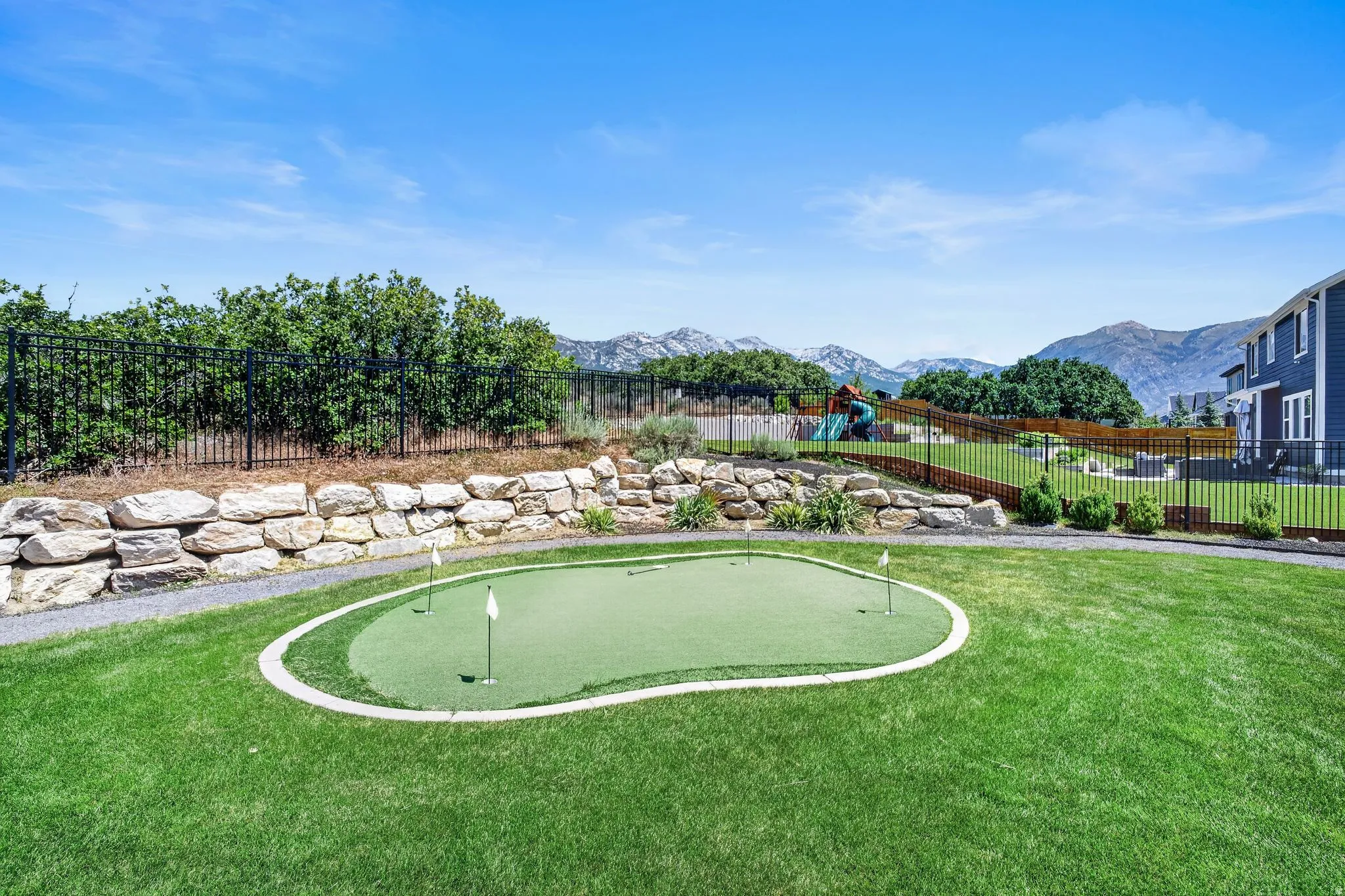 Manicured lawn featuring a putting green with multiple holes