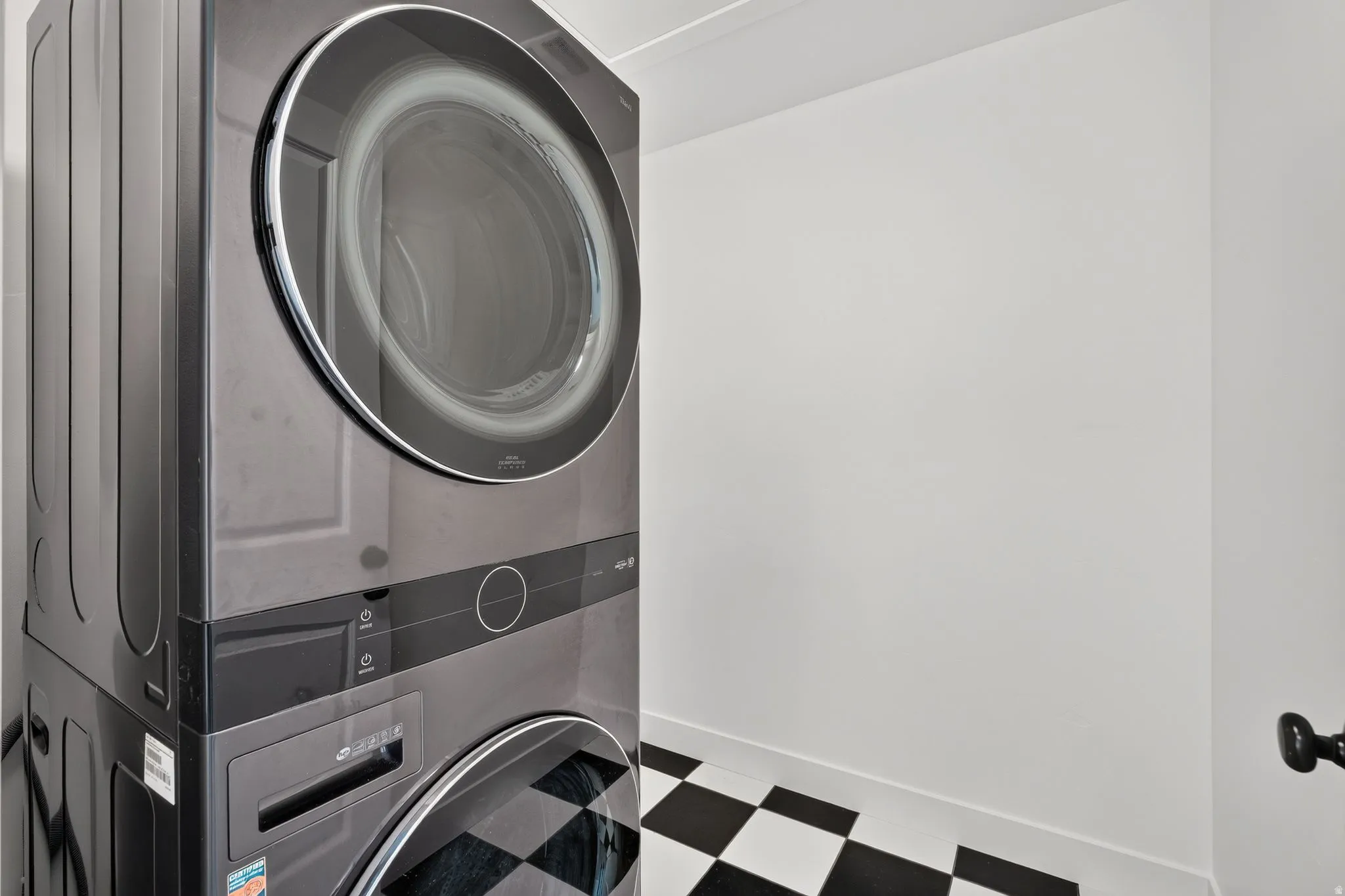 Stacked laundry appliances with a dark finish