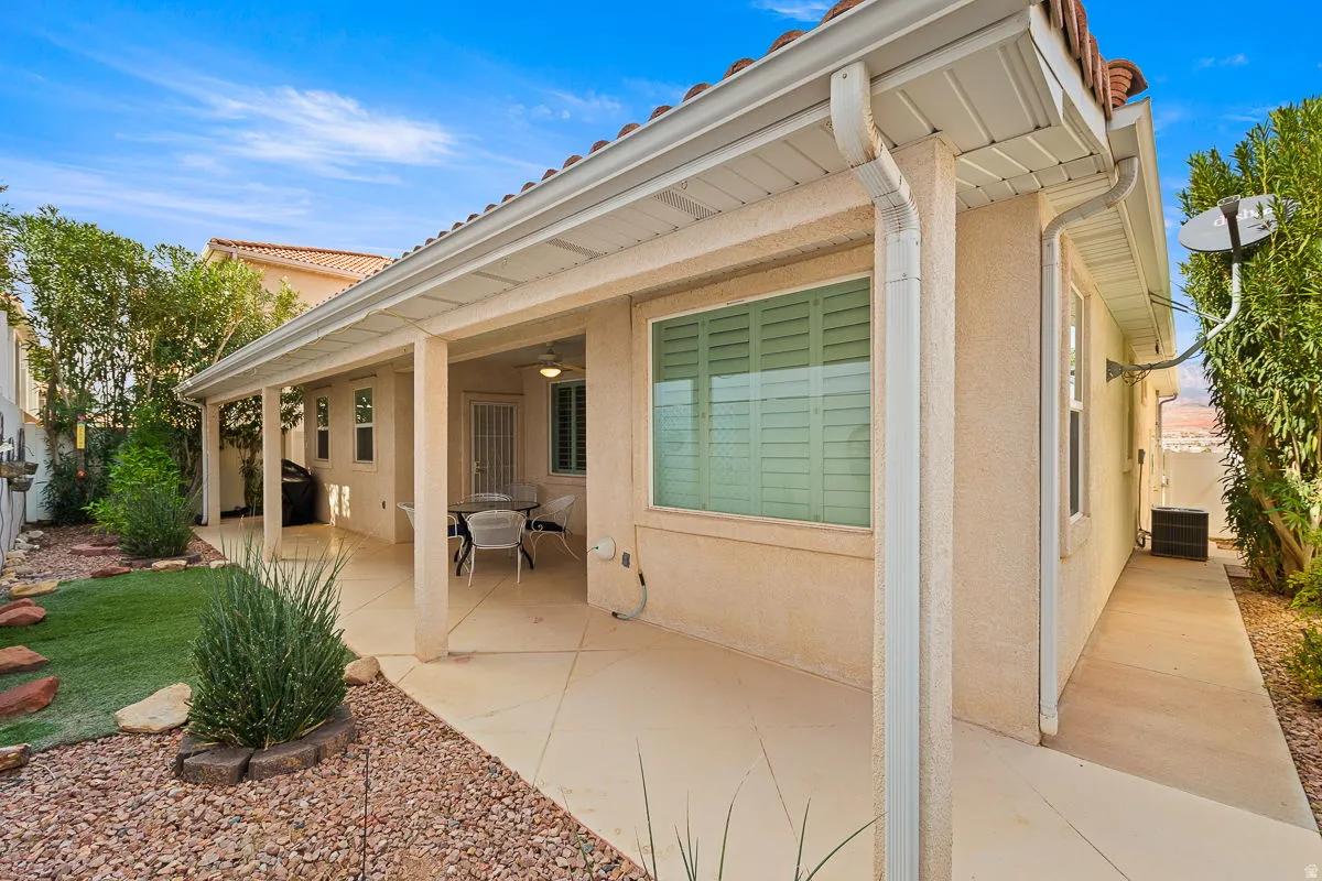 Exterior patio featuring a concrete surface, covered porch, tiled roof, and stucco siding