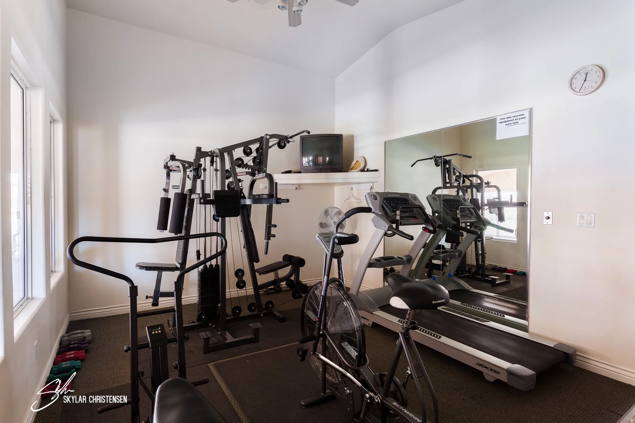 Dedicated exercise room featuring a vaulted ceiling and dual pane windows