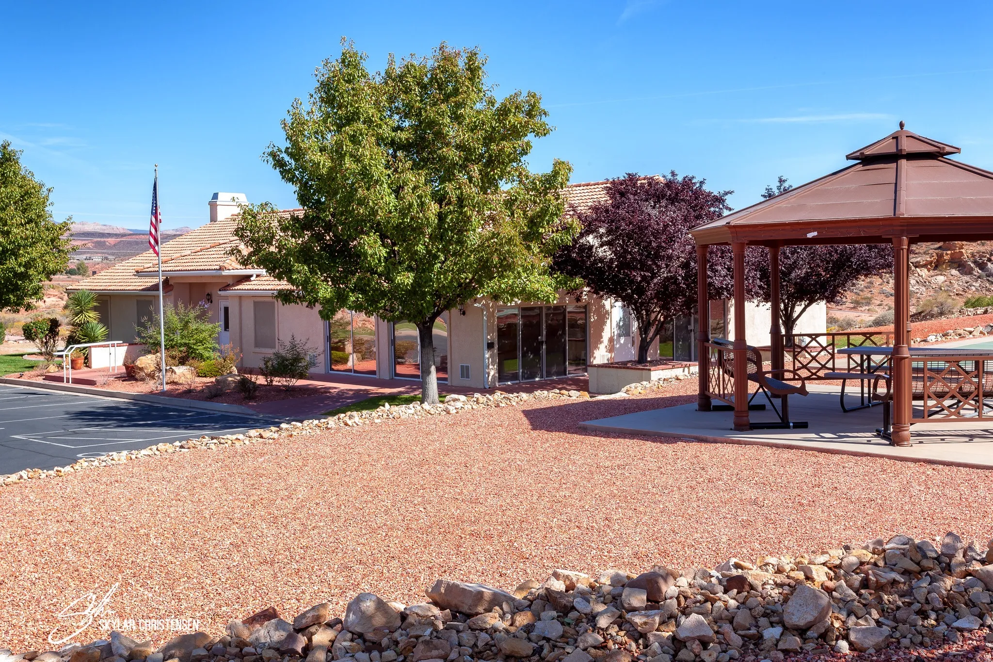 Expansive red gravel area with a decorative stone border