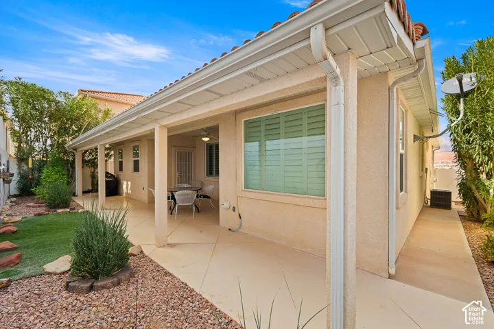 Exterior patio featuring a concrete surface, covered porch, tiled roof, and stucco siding
