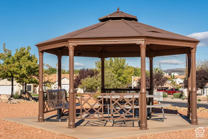 Hexagonal outdoor pavilion featuring a metal frame, tiered roof, and concrete pad