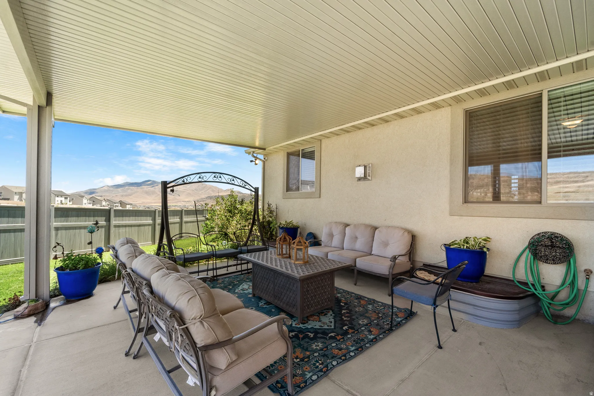 Covered patio featuring a concrete slab, stucco exterior, and slat-paneled ceiling