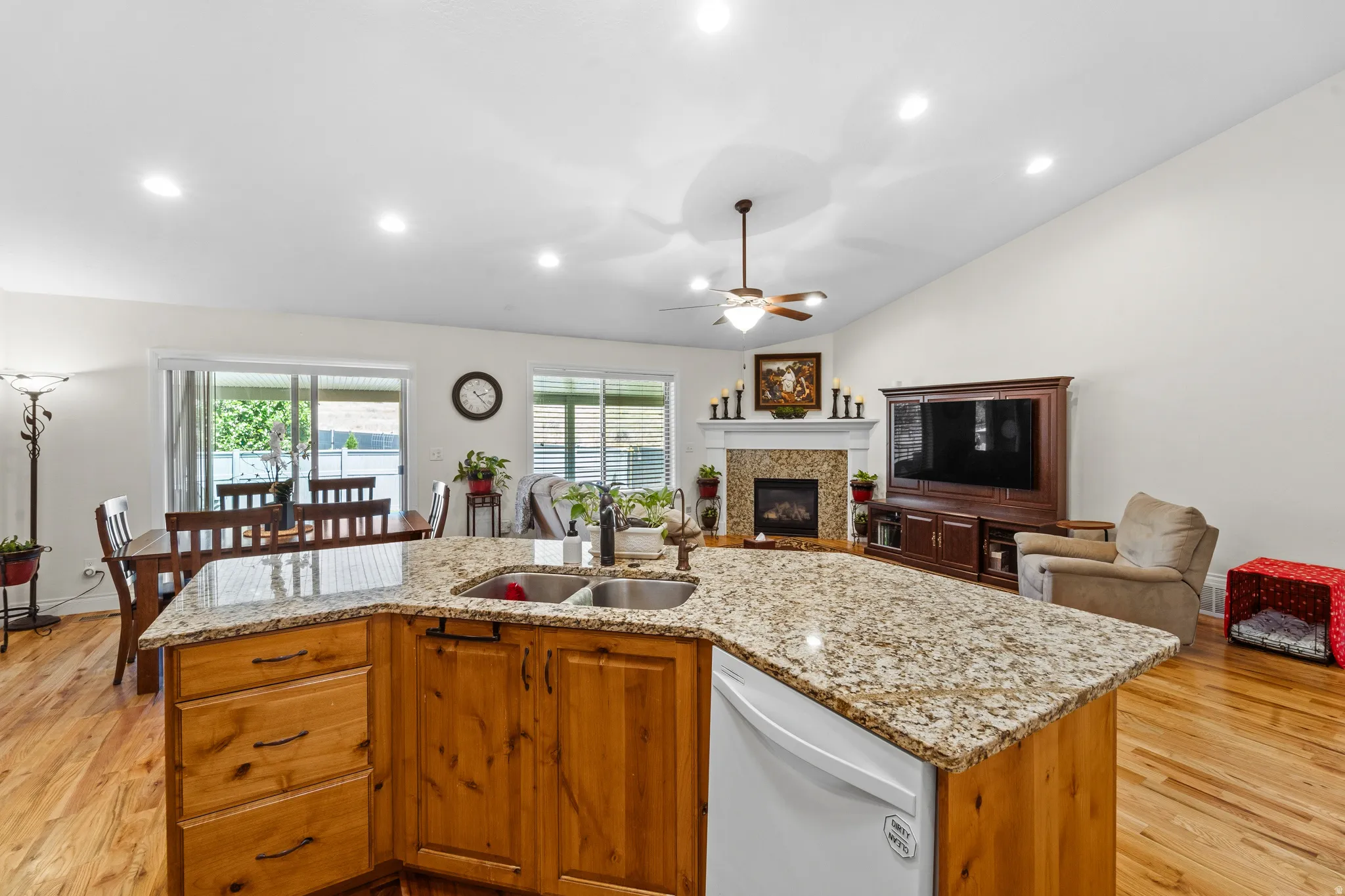 Spacious open-concept interior featuring a kitchen island with stone countertops and a double basin sink