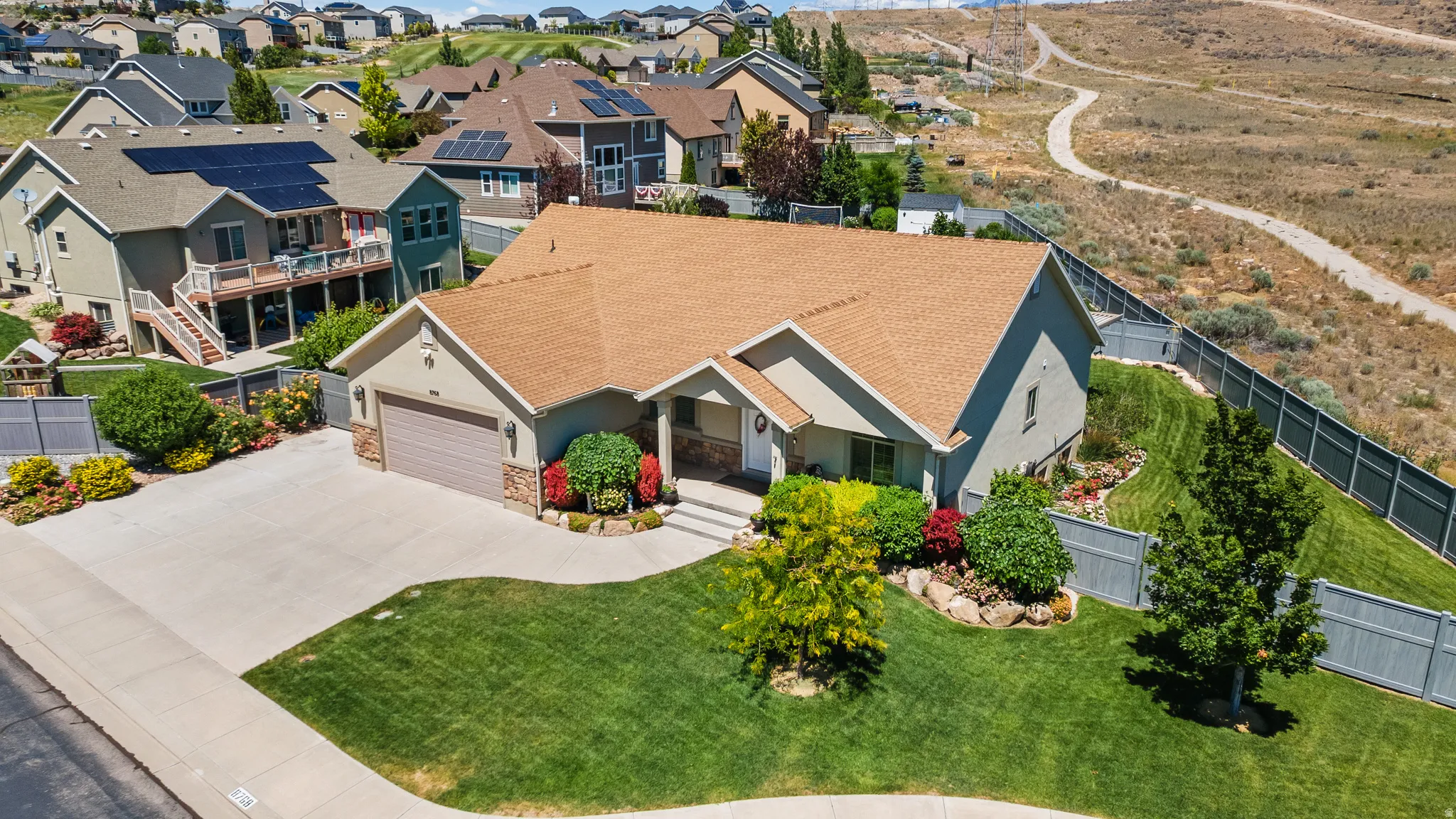 Ranch-style exterior with a two-car garage, stone and stucco facade, and a light brown shingle roof