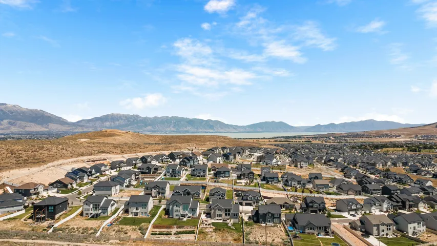 Expansive residential community featuring a variety of single-family homes, clear skies, and distant mountain ranges