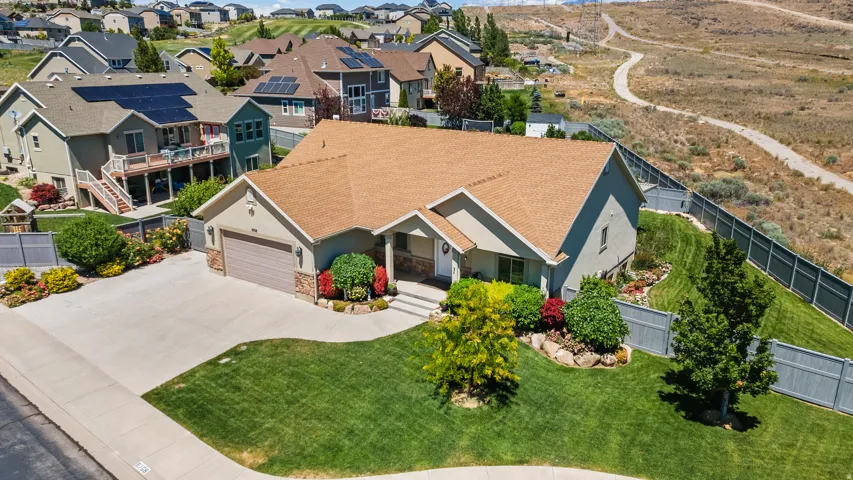 Ranch-style exterior with a two-car garage, stone and stucco facade, and a light brown shingle roof