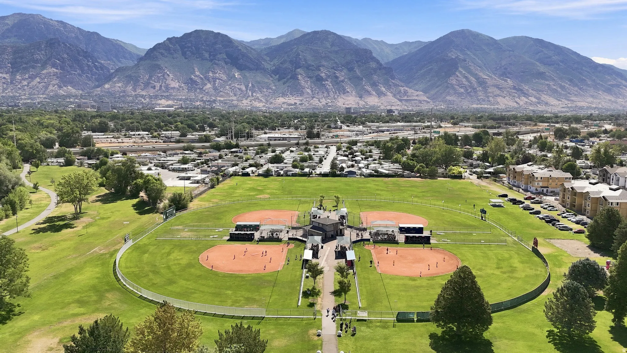 Expansive green space featuring multiple baseball fields, a central complex, and surrounding landscaped parkland