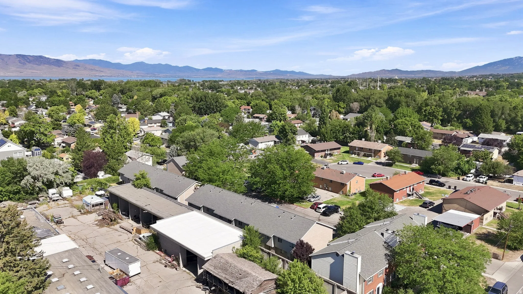 Expansive community with a backdrop of distant mountains and a body of water