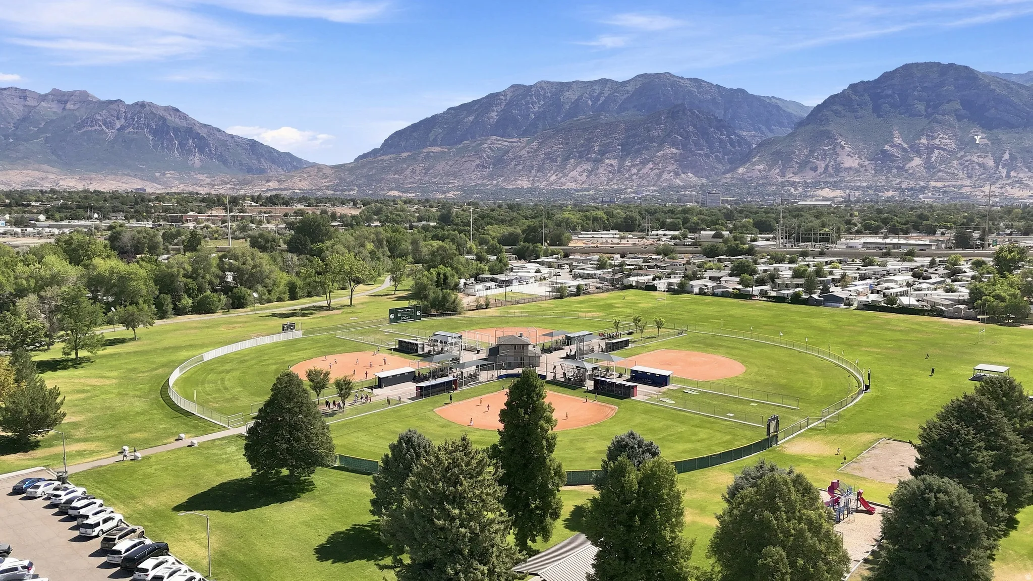 Extensive park grounds featuring multiple baseball diamonds, manicured lawns, and mature trees