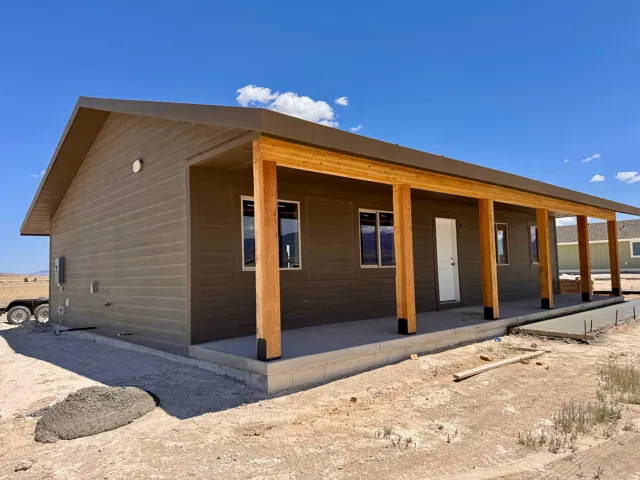 Modern ranch-style home featuring horizontal siding in a neutral tone