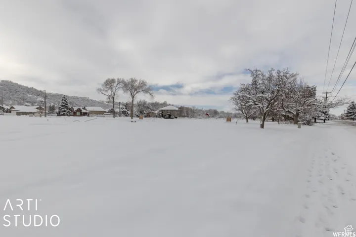 Expansive snow-covered lot featuring a level terrain