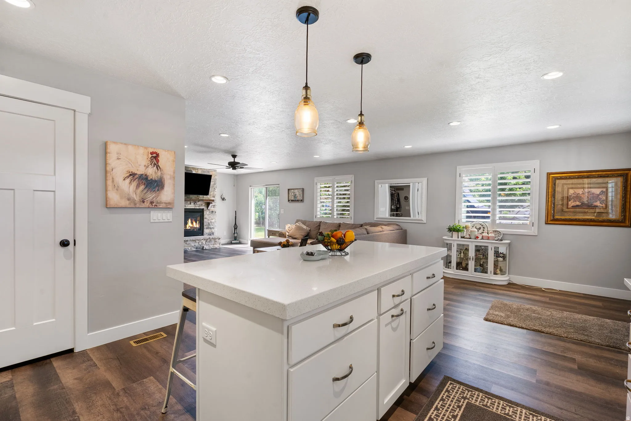 Kitchen island with a light-toned countertop and white cabinetry