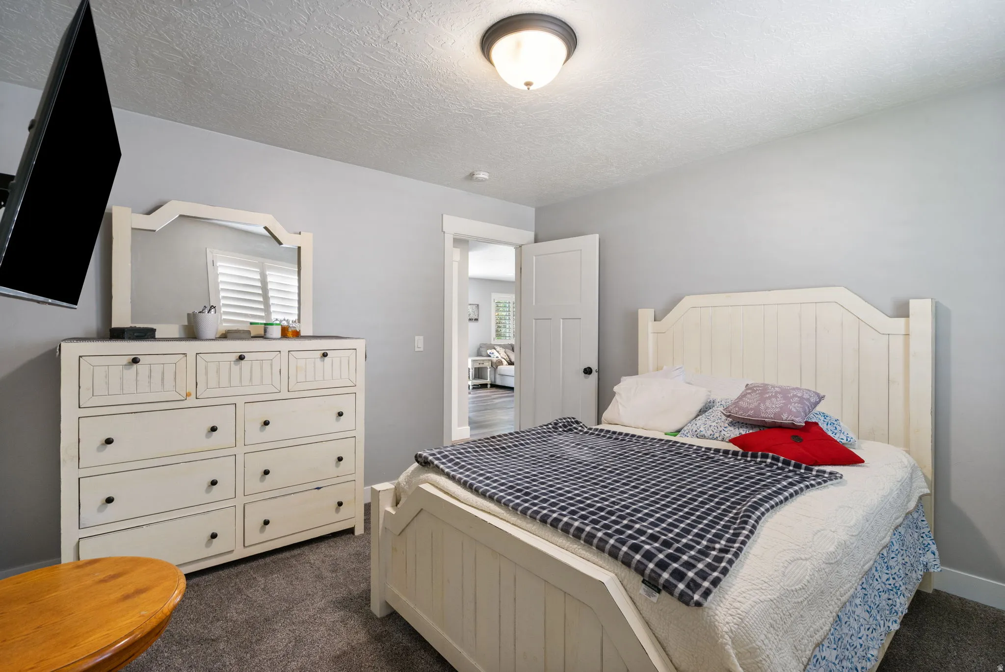 Carpeted bedroom with neutral wall tones and a white paneled door