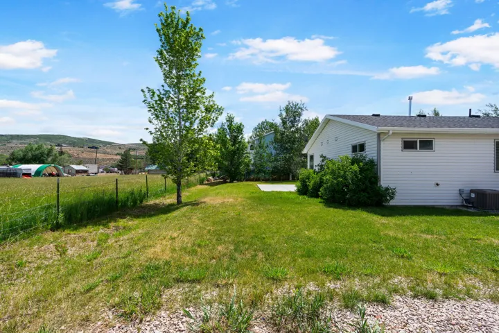 Expansive green lawn bordering a wire fence