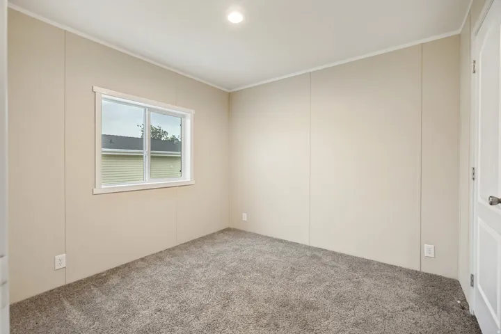 Room featuring neutral panel walls and plush gray carpeting