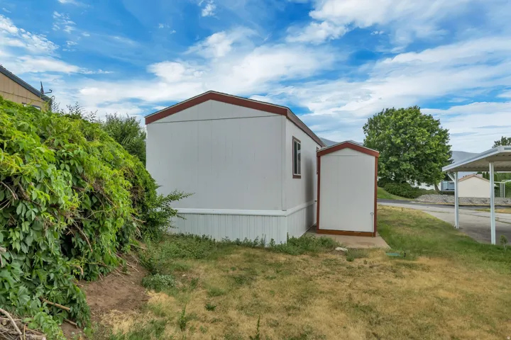White siding exterior with a red trim roofline