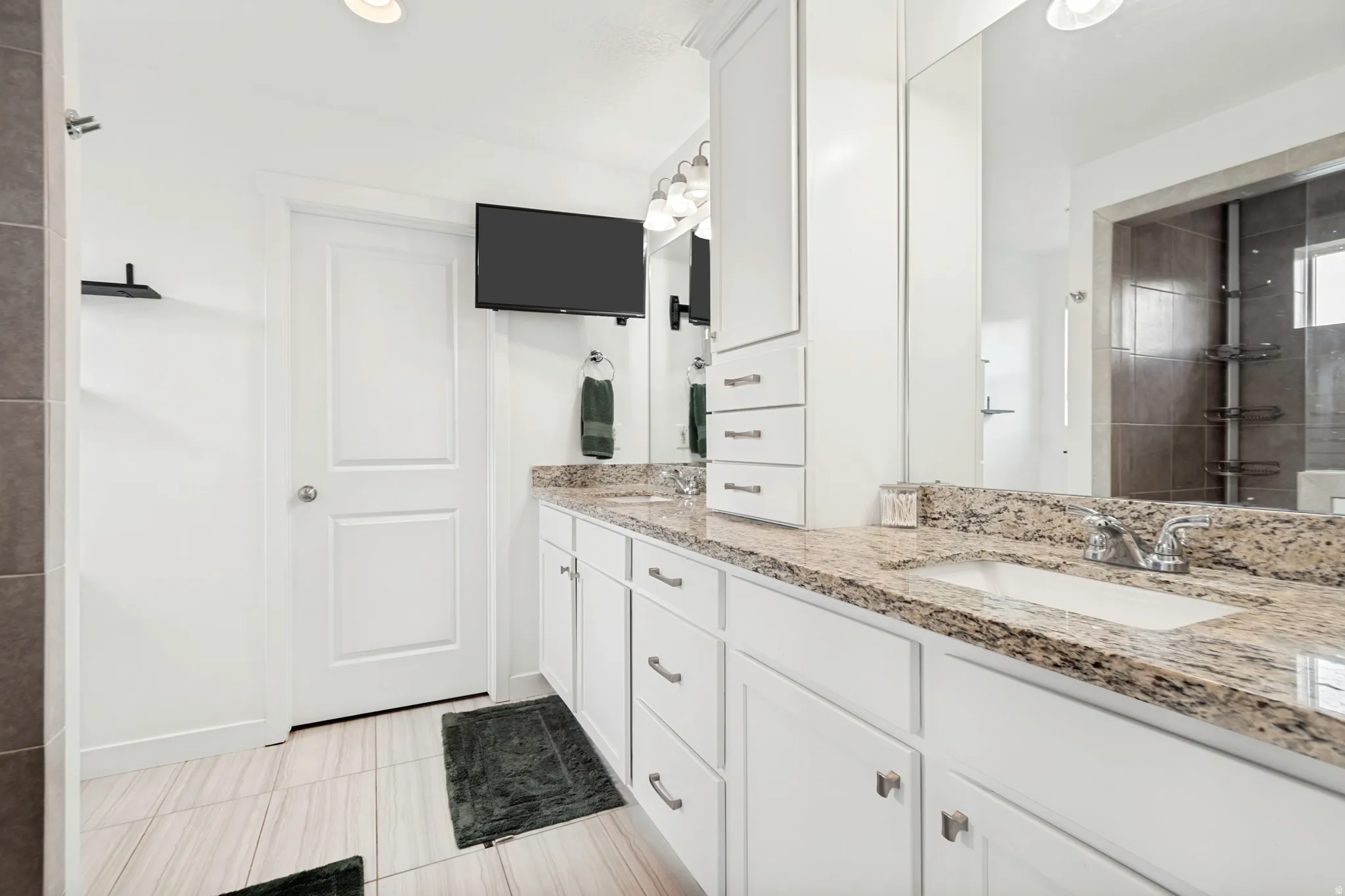 Double vanity featuring integrated sinks and stone countertops