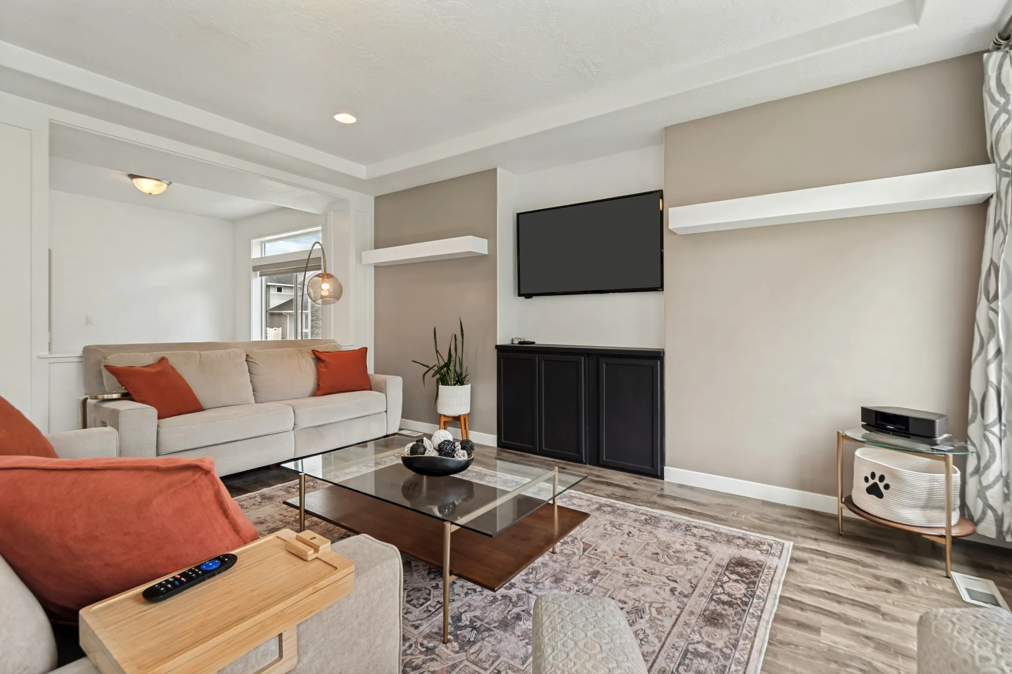 Spacious open-concept living area featuring wood-finish flooring and recessed lighting