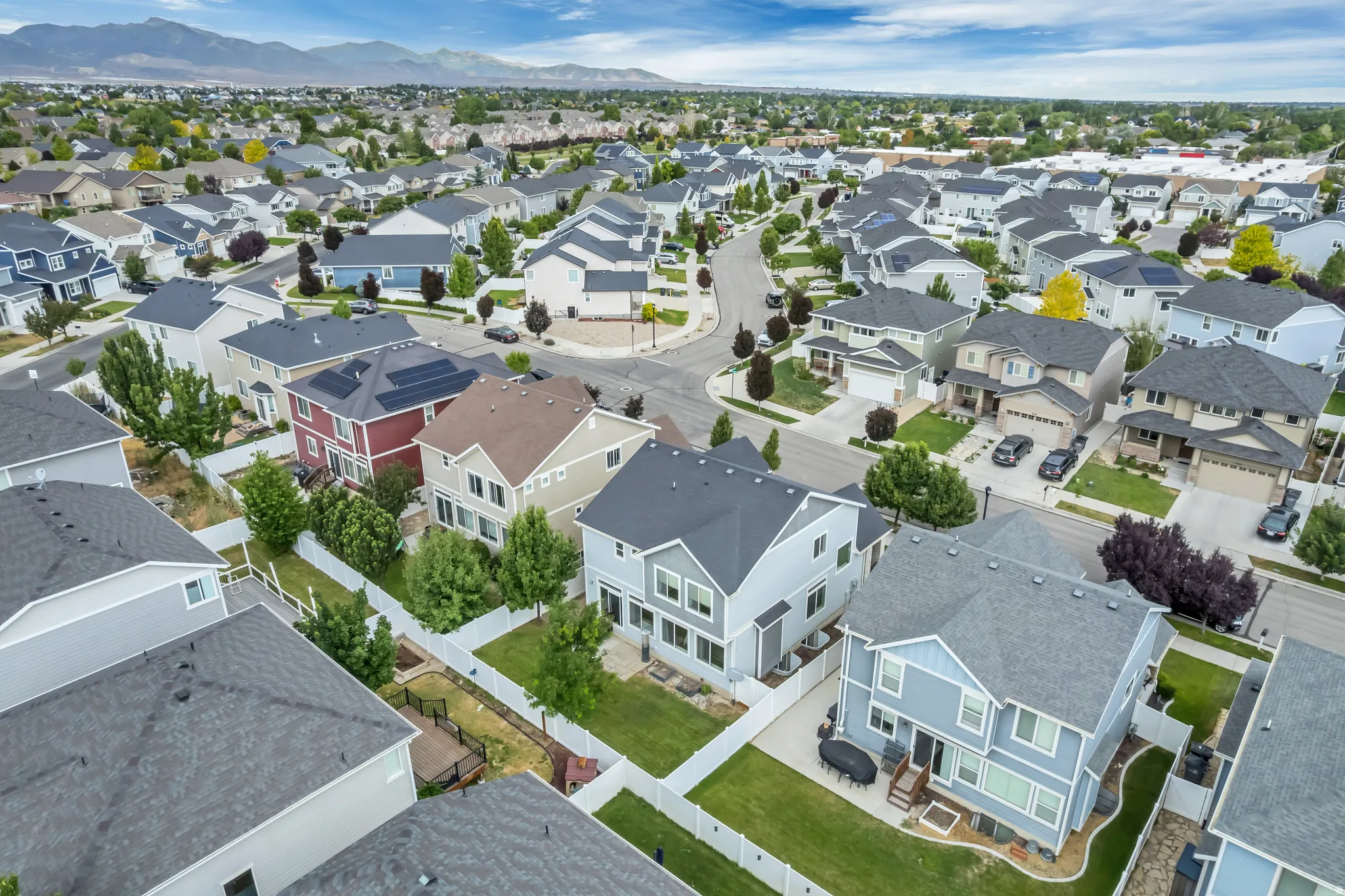Residential neighborhood featuring a variety of two-story homes with pitched roofs, front yards, and driveways