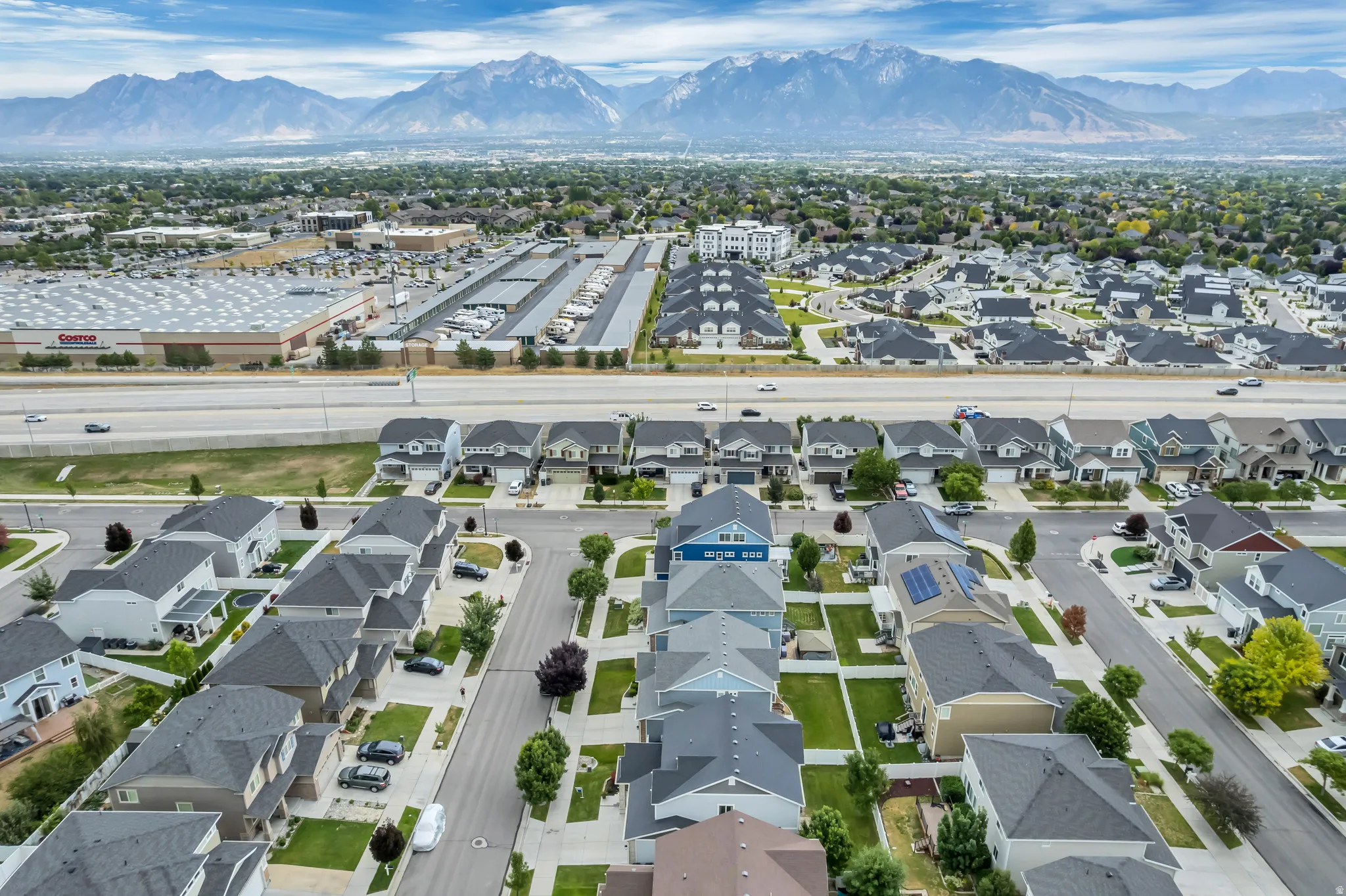 Residential neighborhood featuring a mix of single-family homes and townhomes with mountain scenery in the background