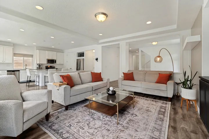 Open-concept living area featuring wood-finish flooring and recessed lighting