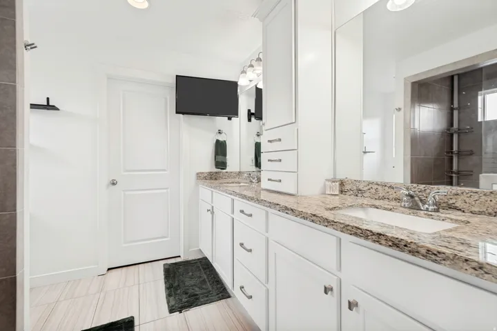 Double vanity featuring integrated sinks and stone countertops