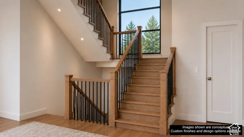 Grand staircase featuring natural wood-finish treads and handrails with black metal balusters